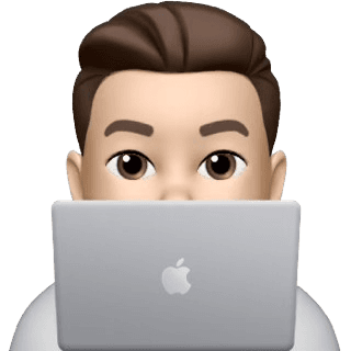 Alen peeking from behind laptop